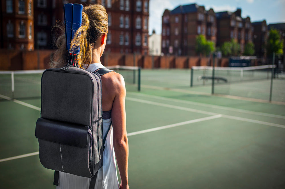 Epirus backpack with leather grip covers on tennis court