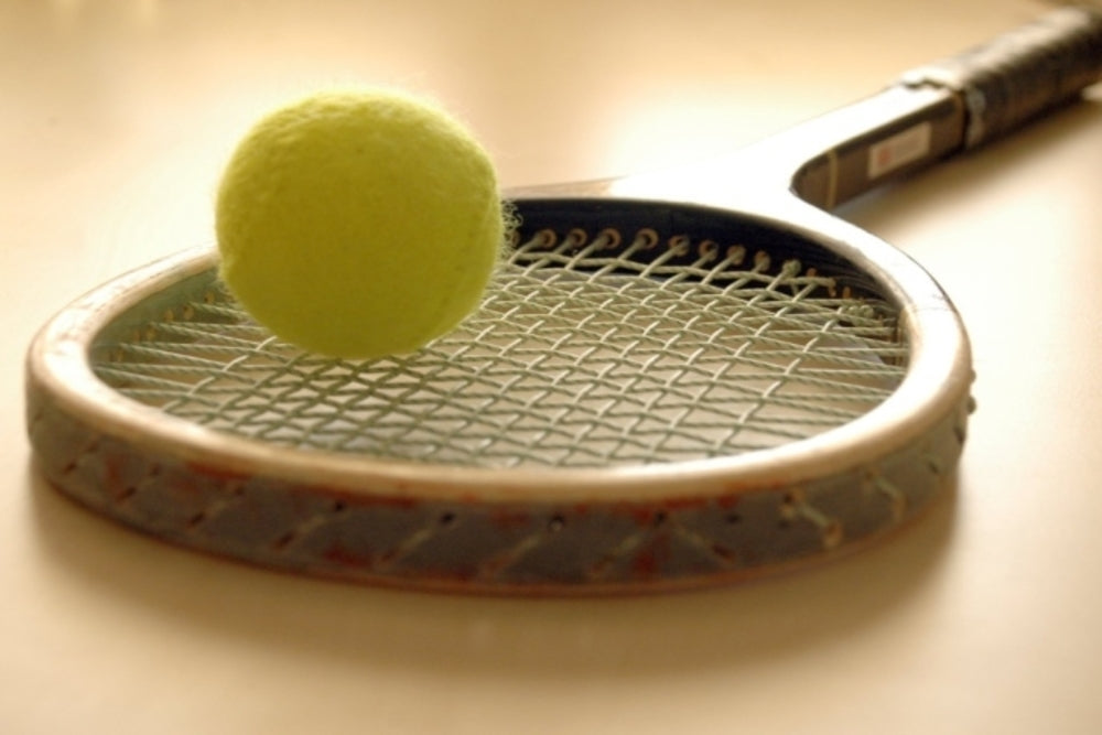 Real Court Tennis racket with ball 