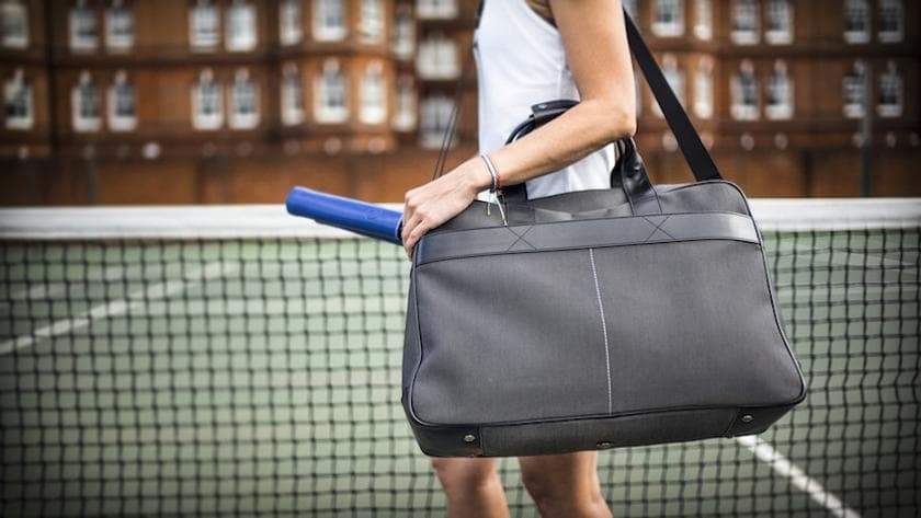 Epirus 24 Hour Bag with electric blue grip covers on tennis court